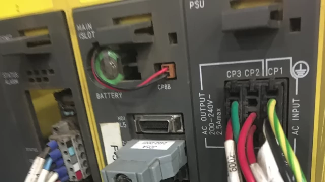 A close-up of a power supply unit with a battery slot labeled "BATTERY"