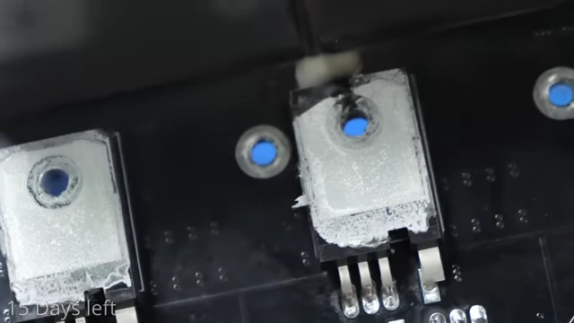 A close-up of a damaged MOSFET on a circuit board, showing an arc mark and residue