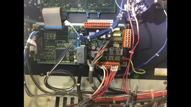 A circuit board with complex wiring, representing outdated robot electronics