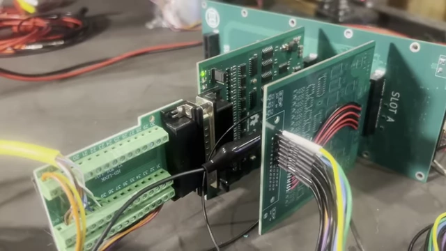 A close-up of a custom serial interface card connected to the backplane