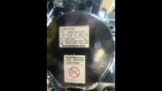 A close-up of a Motoman servo motor nameplate, showing the encoder model