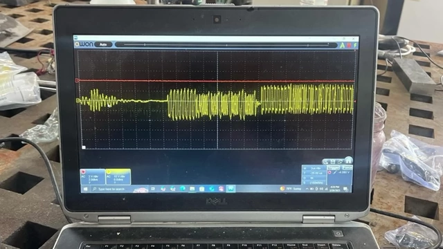 A laptop displaying an oscilloscope trace provided by a community member