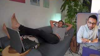 Ali Abdaal lounges on a sofa with a laptop, illustrating a lack of structure in his full-time YouTuber phase.