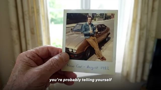 A younger version of the speaker with his new car, representing material pursuits.