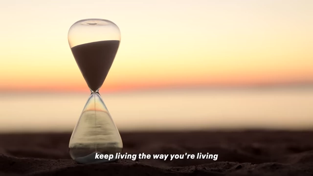 An hourglass with sand steadily falling at sunset, symbolizing the finite and rapidly diminishing nature of time.