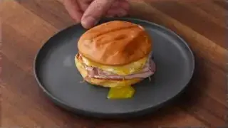 Finished breakfast sandwich with runny yolk