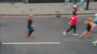 Runners participating in the Paris Marathon on a road.