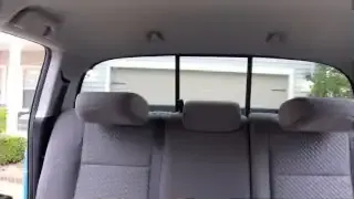 Rear headrests folded down in a Toyota Tacoma, providing improved visibility through the rear window