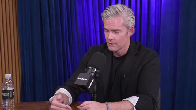 Ryan Serhant uses hand gestures to emphasize a point about negotiation strategy, focusing on listening and mirroring.