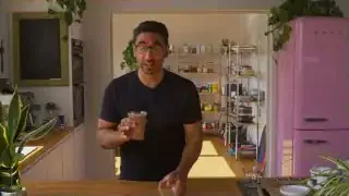 A person holding a blended smoothie, indicating it's a better alternative to green powders.