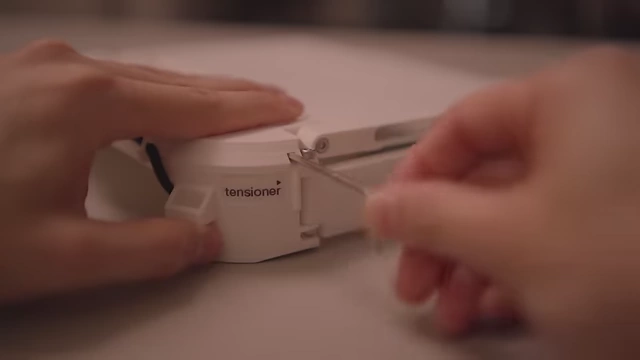 The creator tightening a bolt on the hinge mechanism with an Allen key