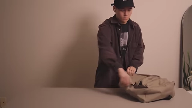 The portable Mac Mini being placed into a backpack