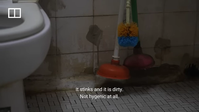 The unhygienic shared toilet facility in Auntie Ha's subdivided flat.