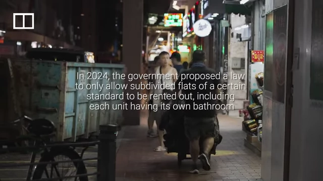 A street view of Hong Kong with text describing the proposed 2024 law for subdivided flats to meet certain standards, including having their own bathrooms.
