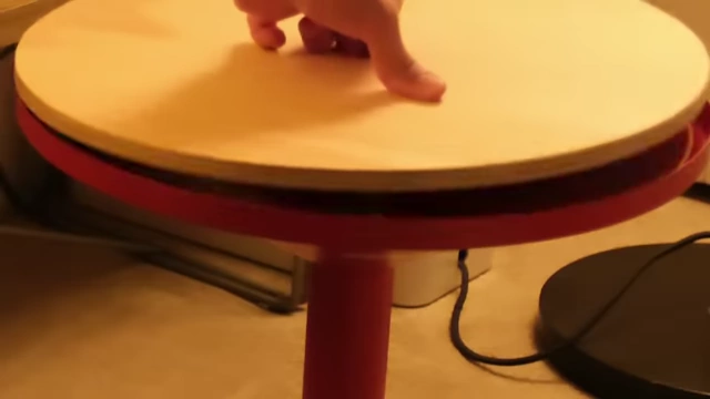 A hand removing the wooden top of the GRIMSARBO side table to reveal a hidden storage compartment