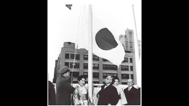 A Japanese flag being raised at a ceremony