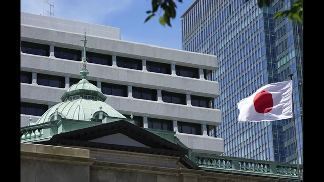 The Bank of Japan building with a Japanese flag waving