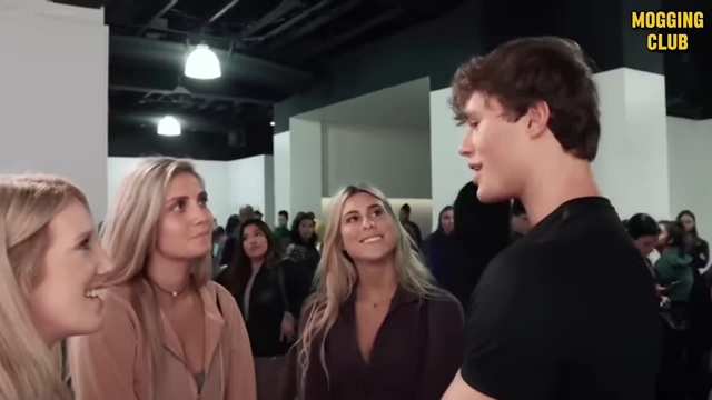 A man talking to several women, illustrating the principle of showing charisma through action rather than just talking about it.