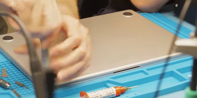 Prying open the MacBook Air bottom cover with a bit