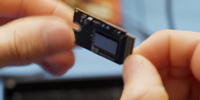 Close-up of the Mac Mini's modular SSD card with two NAND packages