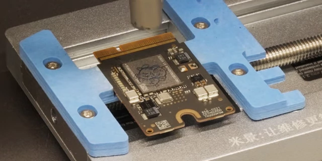 Hot air on Mac Mini NAND chip during soldering, showing flux bubbling