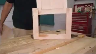 A basic wooden frame with a central panel that is not yet fully inserted, illustrating the concept of a floating panel within a frame.