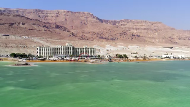 Artist's rendering of a coastal city by turquoise water