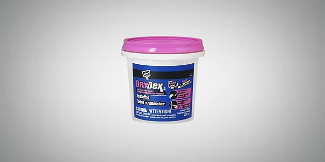 A container of spackling compound, used for filling holes and repairing walls.
