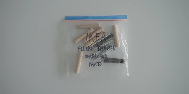 A Ziploc bag containing small furniture parts, clearly labeled with the item's origin and purpose.