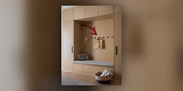 Built-in entryway storage with hooks for easy hanging of jackets and bags, indicated by an arrow.