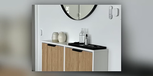 A console table with a tray for organizing small items like keys and sunglasses in an entryway.