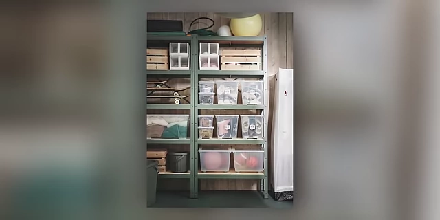 A metal shelving unit organized with numerous clear storage boxes, demonstrating efficient visual storage.