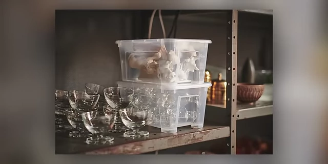 Clear storage boxes holding glassware, allowing for easy visibility of contents.