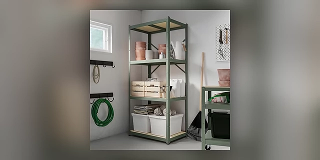 A garage corner with a metal shelving unit, demonstrating effective storage of tools and supplies in clear bins.
