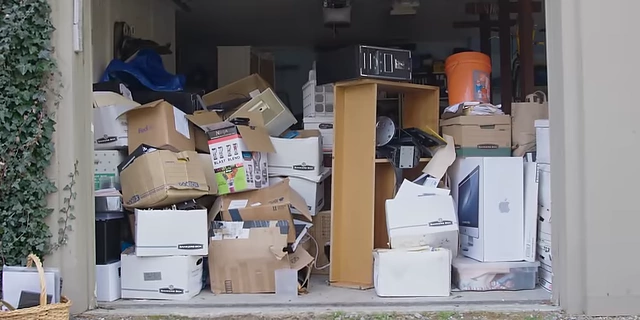 A garage filled with numerous boxes and items, illustrating a significant hoarding issue.