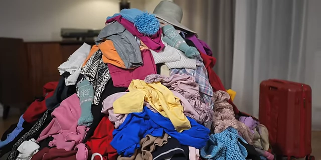 A large pile of clothes, illustrating the accumulation that the 'One-in, One-out' rule aims to prevent.