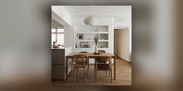A minimalist kitchen and dining area with built-in shelving, illustrating successful organization in high-traffic zones.