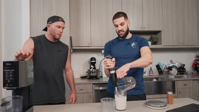 Nick uses an immersion blender to mix ingredients for the ice cream base.