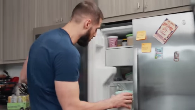 Nick places a pint of ice cream base into the freezer.
