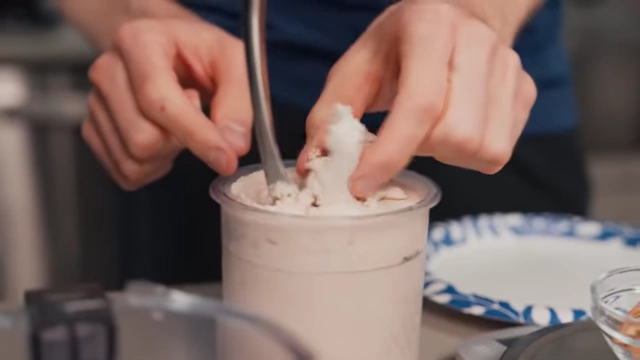Nick scoops out the powdery center of the partially spun ice cream.