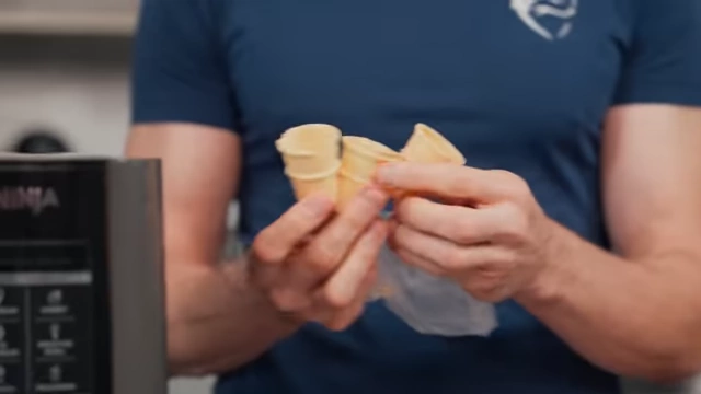 Nick holds up small, 5-calorie mini cones for serving the ice cream.