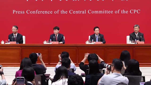 High-ranking members of the Chinese Communist Party are shown at a press conference.