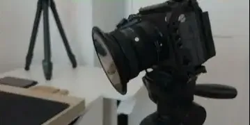 A Sigma 10-18mm F2.8 DC DN Contemporary lens attached to a camera on a tripod.