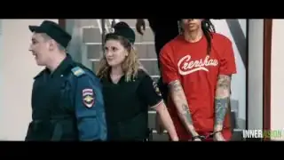 Brittney Griner in handcuffs being escorted