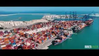 Shipping containers being loaded at a busy port