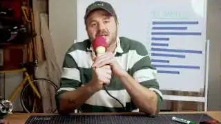 The speaker presents his list of 10 habits on a whiteboard.