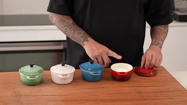 Andy's selection of four essential salts: table salt, flaky sea salt, smoked salt, and natural sea salt, each presented in a small, colorful ceramic pot.