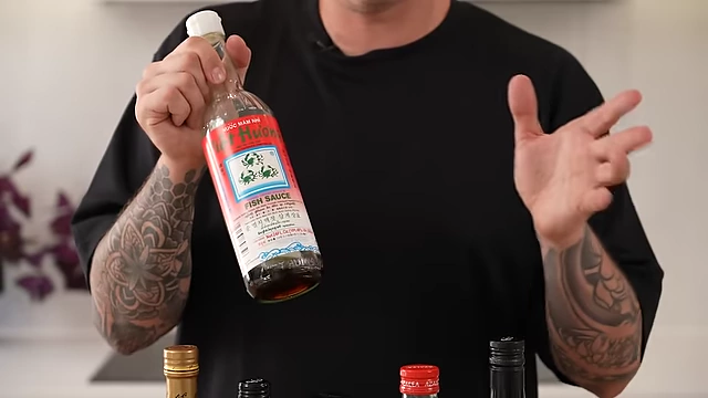 A bottle of good quality fish sauce, a recommended essential for authentic Asian cooking, often found in specialty Asian grocers.