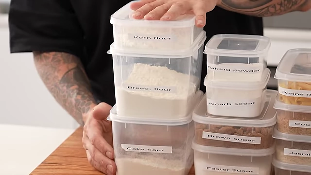 Labeled containers of essential flours for beginners (corn flour, bread flour, cake flour) and leavening agents (baking powder, bicarb soda).