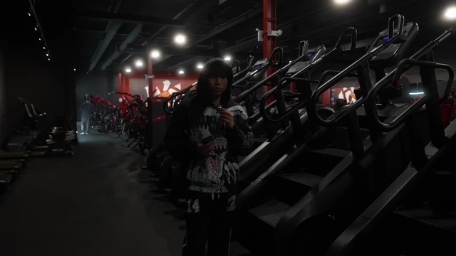 The speaker standing by stair master machines at the gym